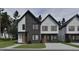 Modern townhome showcasing a stylish facade with a mix of light and dark gray materials and contrasting black trim at 1804 Pershing Rd, Raleigh, NC 27608