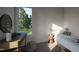 Bright bedroom featuring a vanity, sleek decor, and large windows with a scenic outdoor view at 1806 Pershing Rd, Raleigh, NC 27608