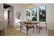 Bright dining room with large windows, wood floors, stylish light fixture, and seating for six at 1806 Pershing Rd, Raleigh, NC 27608