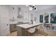 A modern kitchen featuring a large island with seating, ample counter space, and stylish pendant lighting at 1806 Pershing Rd, Raleigh, NC 27608