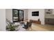 Cozy living room featuring a black sliding glass door, TV, modern decor, and comfortable seating at 1806 Pershing Rd, Raleigh, NC 27608