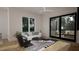 Bright living room with large windows, a modern rug, stylish decor, and comfortable seating at 1806 Pershing Rd, Raleigh, NC 27608