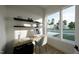 Bright home office featuring a modern desk setup and large windows offering views of the outdoors at 1806 Pershing Rd, Raleigh, NC 27608