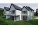 View of the rear of the modern homes with screened porch and rear entrance to living area at 1806 Pershing Rd, Raleigh, NC 27608