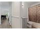 Hall bathroom features shower-tub, gray vanity, and toilet next to living area at 2 Capri Ter, Durham, NC 27703