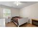 Bright bedroom with hardwood floors, a ceiling fan and a bed with white frame at 2 Capri Ter, Durham, NC 27703