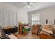 Bright bedroom featuring a ceiling fan and large closet for ample storage at 2 Capri Ter, Durham, NC 27703