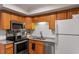 Well-lit kitchen features wood cabinets, white subway tile backsplash, and stainless steel appliances at 2 Capri Ter, Durham, NC 27703