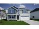 Charming two-story home with a modern design, well-manicured lawn, and an attached two car garage at 228 Alice Trace Place, Angier, NC 27501
