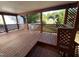 Back deck area offers outdoor living space with wood flooring, lattice railing, and views of the backyard at 2302 Chautauqua Ave, Durham, NC 27707