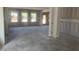 Bright unfinished living room awaits conversion with windows and smooth concrete flooring at 245 Tidal Pool Way, Cary, NC 27519