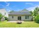 Home's backyard features stone patio, a fire pit, and well-maintained lawn at 248 Inkster Cv, Raleigh, NC 27603
