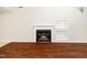 Close-up of a fireplace with white mantel and built-in shelving, set in wood flooring at 248 Inkster Cv, Raleigh, NC 27603