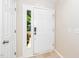 Welcoming foyer featuring a white front door with sidelight and neutral tile flooring at 248 Inkster Cv, Raleigh, NC 27603