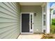 Inviting front door with sidelight, black hardware, and stylish exterior lighting at 248 Inkster Cv, Raleigh, NC 27603