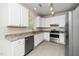 Well-lit kitchen features stainless steel appliances, granite countertops, and white cabinets at 248 Inkster Cv, Raleigh, NC 27603