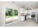 Kitchen featuring stainless steel appliances, white cabinets, granite countertops, and a sliding glass door at 248 Inkster Cv, Raleigh, NC 27603