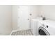 Laundry room with washer and dryer, neutral paint color, and tile flooring at 248 Inkster Cv, Raleigh, NC 27603