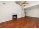 Open living room featuring a fireplace, built-in shelving, and rich wood flooring at 248 Inkster Cv, Raleigh, NC 27603