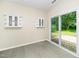 Sunroom with tile flooring, sliding glass doors, and built-in cabinets at 248 Inkster Cv, Raleigh, NC 27603