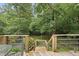 Wooden deck with railings overlooking the backyard, surrounded by trees at 2705 Vestry Way, Raleigh, NC 27613