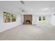 Basement living space includes a brick fireplace, recessed lighting, and double doors to the outside at 2705 Vestry Way, Raleigh, NC 27613