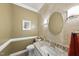 Charming powder room featuring a stone tiled wall and granite countertop vanity at 2705 Vestry Way, Raleigh, NC 27613