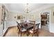 Formal dining room features a chandelier, hardwood flooring, wainscoting and space for six at 2705 Vestry Way, Raleigh, NC 27613