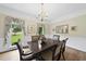 Traditional dining room with hardwood floors, large windows, chandelier, and floral wallpaper at 2705 Vestry Way, Raleigh, NC 27613