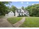 Beautiful white home with a detached garage and lush green lawn at 2705 Vestry Way, Raleigh, NC 27613