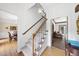 Elegant foyer with hardwood floors, staircase, and view into living spaces at 2705 Vestry Way, Raleigh, NC 27613