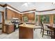 Cozy kitchen with wooden cabinets, tile backsplash, stainless steel appliances and a butcher block island at 2705 Vestry Way, Raleigh, NC 27613