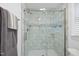 Updated shower with glass doors, and white tile, including corner shelves at 2705 Vestry Way, Raleigh, NC 27613