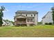 Backyard of home featuring a deck and expansive grassy lawn at 271 W Amber Oak Dr, Selma, NC 27576