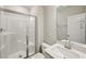 A clean bathroom featuring a glass enclosed shower, toilet and white sink with vanity at 271 W Amber Oak Dr, Selma, NC 27576