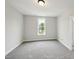 Clean bedroom with neutral walls, grey carpet, bright window and white trim at 271 W Amber Oak Dr, Selma, NC 27576