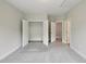 Spacious carpeted bedroom features an open closet and neutral color palette at 271 W Amber Oak Dr, Selma, NC 27576