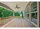 Covered wooden deck featuring ceiling fan and views of the backyard at 271 W Amber Oak Dr, Selma, NC 27576