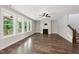 Spacious living room with hardwood floors, fireplace, abundant natural light, and stair access at 271 W Amber Oak Dr, Selma, NC 27576
