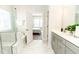 Well-lit bathroom featuring double-sink vanity and access to the bedroom at 2918 Heirloom Way, Apex, NC 27502