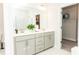 Lovely bathroom featuring double vanity sinks and a view into the closet at 2918 Heirloom Way, Apex, NC 27502