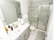 Modern bathroom featuring a glass-enclosed shower, gray vanity, and tile flooring at 2918 Heirloom Way, Apex, NC 27502