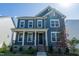 Beautiful two-story home with a covered porch and manicured landscaping at 2918 Heirloom Way, Apex, NC 27502