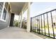Spacious covered front porch with white columns and black railings, perfect for relaxing at 2918 Heirloom Way, Apex, NC 27502
