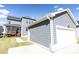 View of home's detached two car garage, back porch and paved driveway, siding matching house and blue skies at 2918 Heirloom Way, Apex, NC 27502