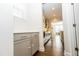 Hallway featuring hardwood floors and cabinetry that leads into other living spaces at 2918 Heirloom Way, Apex, NC 27502
