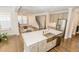 Open-concept kitchen featuring stainless steel appliances, a large island and bar seating at 2918 Heirloom Way, Apex, NC 27502