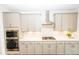 Modern kitchen with gray cabinets, stainless steel appliances, and a stylish backsplash at 2918 Heirloom Way, Apex, NC 27502