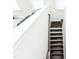 A staircase with dark wood steps and white trim; natural light fills the space at 2918 Heirloom Way, Apex, NC 27502