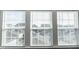View of neighborhood homes seen through a window with white blinds at 2918 Heirloom Way, Apex, NC 27502